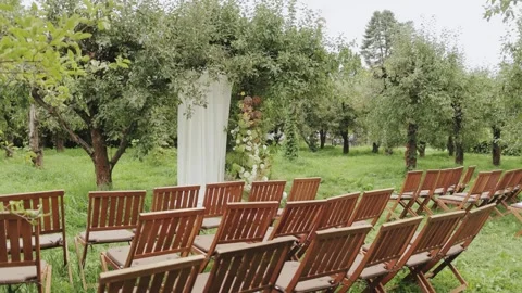 A beautiful rustic wedding ceremony setup can be arranged in a charming orchard Stock Footage 306156175