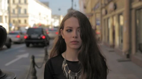 Beautiful sad woman walking in the city (messy mascara on face). Slow motion. Stock Footage