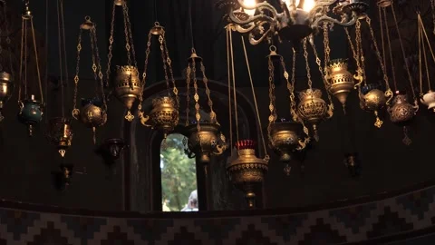 Beautiful sanctuary lamps dangle from the ceiling in a historic church. 库存影片 288245988