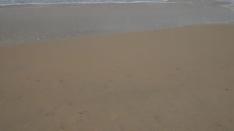 Beautiful sand beach with soft wave in sea water , cloudy rainy sky day Stock Footage 94500655