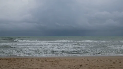 Beautiful sand beach with soft wave in sea water , cloudy rainy sky. Stock-Footage 94512798