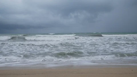 Beautiful sand beach with soft wave in sea water , cloudy rainy sky. Stock-Footage 94514640