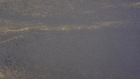 Beautiful sand pattern formed by yellow and black grains 写真素材
