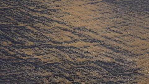 Beautiful sand pattern formed by yellow and black grains Foto stock