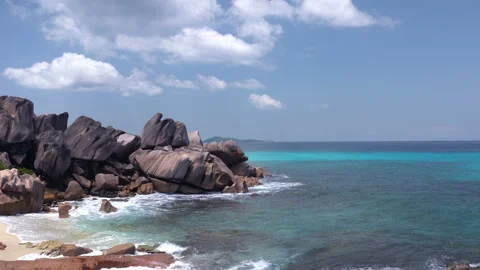 Beautiful sandy beach with blue sky and ocean waves on an exotic island Stock Footage 108647316
