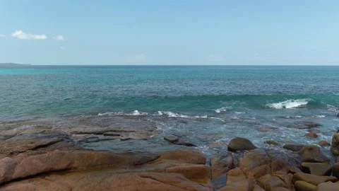 Beautiful sandy beach with blue sky and ocean waves on an exotic island Stock Footage 108647404