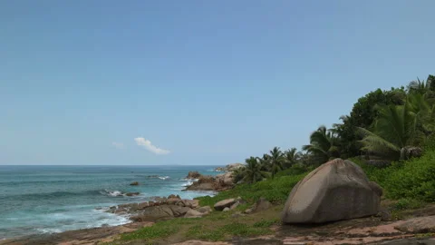 Beautiful sandy beach with blue sky and ocean waves on an exotic island Stock Footage 108647550