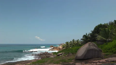 Beautiful sandy beach with blue sky and ocean waves on an exotic island Stock Footage 108647600