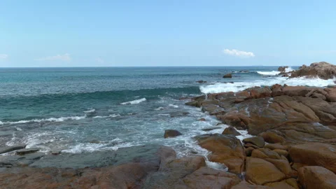 Beautiful sandy beach with blue sky and ocean waves on an exotic island Stock Footage 109256331