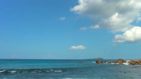 Beautiful sandy beach with blue sky and ocean waves on an exotic island Stock Footage 109257527