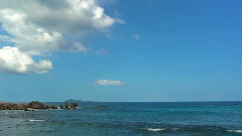 Beautiful sandy beach with blue sky and ocean waves on an exotic island Stock Footage 109257533