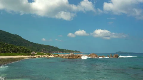 Beautiful sandy beach with blue sky and ocean waves on an exotic island Stock Footage 110039965