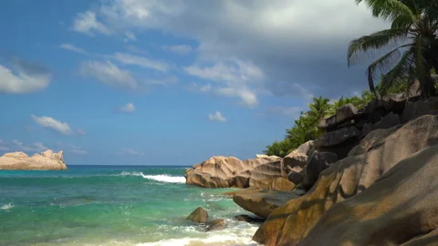 Beautiful sandy beach with blue sky and ocean waves on an exotic island Stock Footage 110042364
