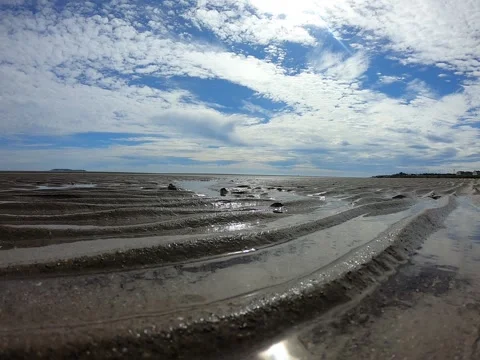 Beautiful sandy beach with bright reflected blue sky. Stock Footage 158573277