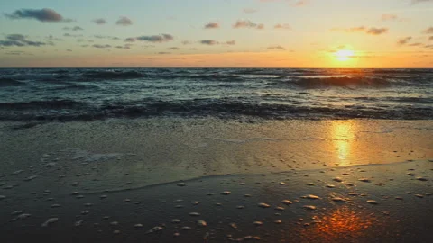 Beautiful  sandy beach during sunset.  Rolling ocean waves to the sandy shore Stock Footage 198925382