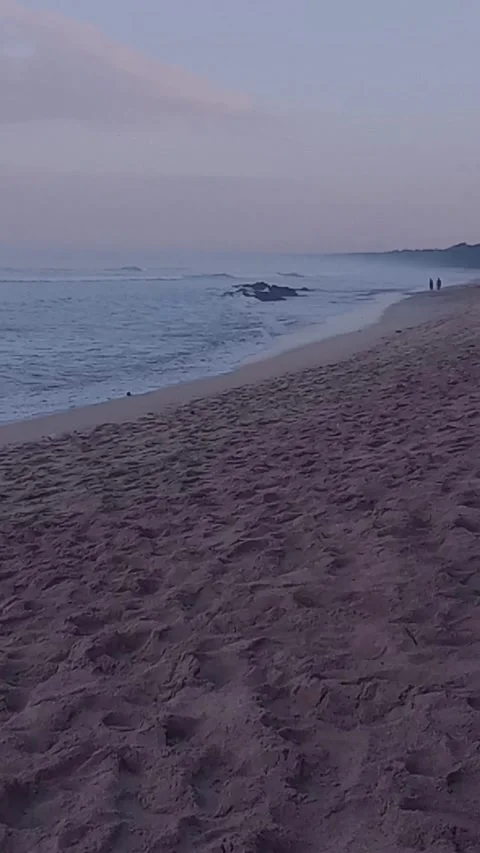 Beautiful sandy beach with ocean waves crashing on shore at sunset Stock Footage 341803688