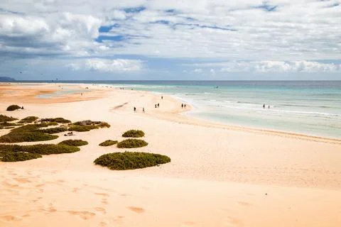 The beautiful sandy beach of Risco del Paso in Fuerteventura with tourists Stock Photos