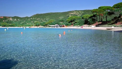 Beautiful sandy beach with rocks and tourquise clear water, Corsica, France, Eur Stock Footage 73873798