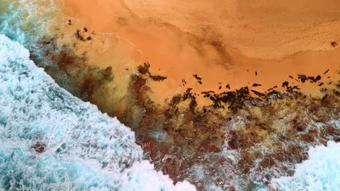 Beautiful sandy beach with some rocks sticking out from sand Stock Footage 310742290