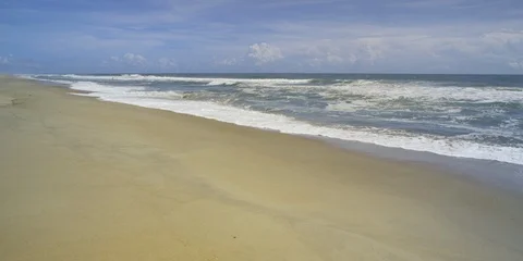Beautiful scene of waves reaching the beach on a sunny day, wide shot Stock Footage 103492790