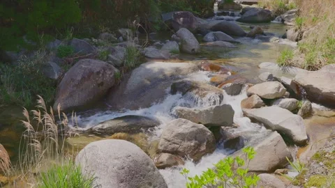 Beautiful scenery of a clear river flowing through mountain rocks Stock Footage 332866085