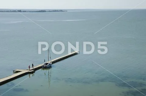 Beautiful scenery of the marina on the sea for mooring yachts with people Stock Photos