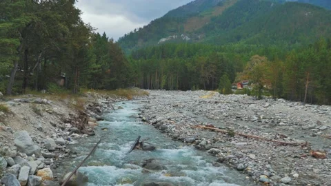 Beautiful scenery of a mountain river sream flowing over the rocks in the middle Video stock 219801247