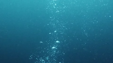 Beautiful scuba diving bubbles rising through the deep blue ocean water Stock Footage 336840262