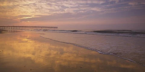 Beautiful sea, dramatic sky and pier at a distance NC coast Atlantic Ocean    Stock Footage 103494649