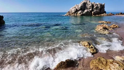 Beautiful sea view on an empty rocky beach with blue sky in Spain, 4K Stock Footage 277112165
