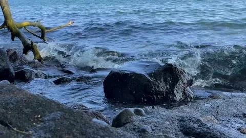 Beautiful sea waves hitting rocks in middle of sunny day. Stock Footage 290259089