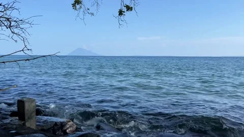 Beautiful sea waves hitting rocks in middle of sunny day. Stock Footage 290259094