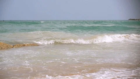 Beautiful sea waves roll on a sandy beach with tourists. slow motion, 1920x1080 Stock Footage 87448747