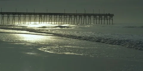Beautiful sea waves rolling beneath the pier at sunrise Video stock 103487811