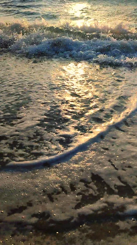 Beautiful sea waves rolling on sand of seashore during sunrise or sunset Stock Footage 305906982