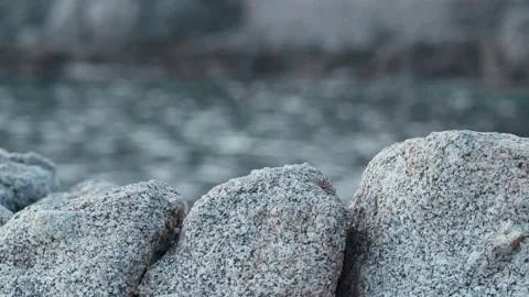 Beautiful seascape on a cloudy day. Light ripples on the water and grey rocks Stock Footage 185546462