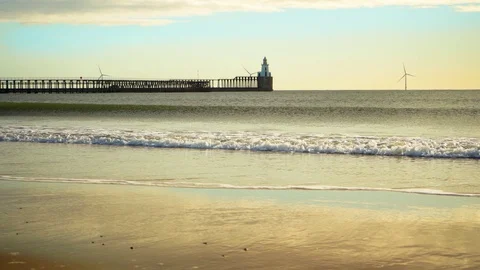 Beautiful seascape with rolling waves, waves beautifully roll onto a sandy beach Stock Footage 128210737