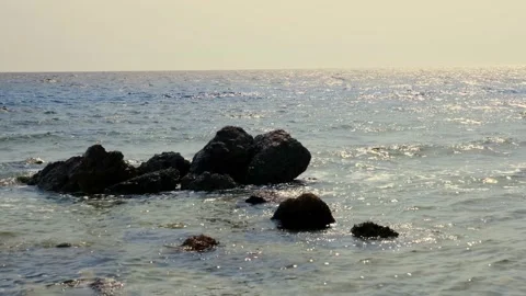 Beautiful seascape. small surf waves with white foam, breaking on rocks in Stock Footage 136896135
