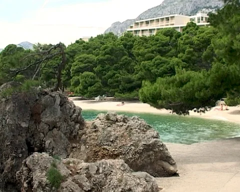 Beautiful seaside of Brela lagoon thru large porous marine textured stones Stock Footage 106552968