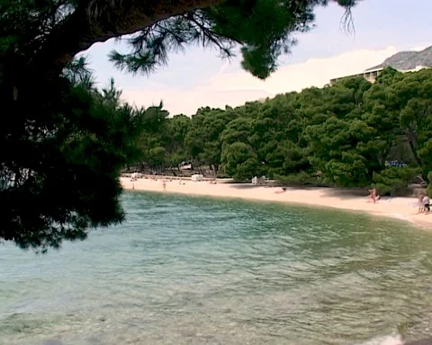 Beautiful seaside of Brela lagoon thru large porous marine textured stones Stock Footage 106552976