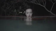 Beautiful Seductive Woman Wearing Red Dress In Outdoor Pool At Night Stock Footage