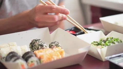 A beautiful selection of sushi rolls is elegantly displayed on a platter with Stock Footage 280307569