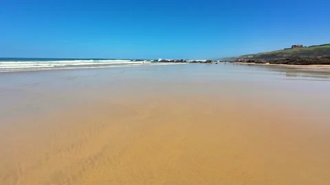 A Beautiful Serene Beach View Showcasing a Clear Blue Sky and Gentle, Soothing Stock Footage 303734277