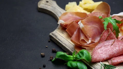 A beautiful serving board of bacon pastrami and sausage. Slow motion Stock Footage 133604335