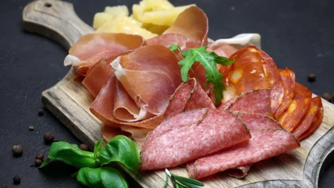 A beautiful serving board of bacon pastrami and sausage. Slow motion Stock Footage 133604559