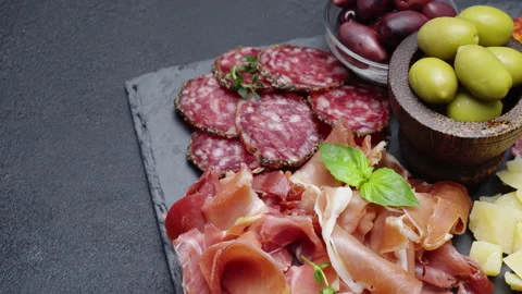 A beautiful serving board of bacon pastrami and sausage. Slow motion Stock Footage 133604602