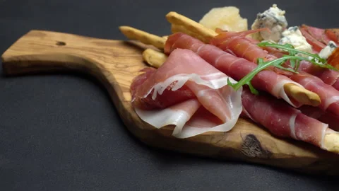 A beautiful serving board of bacon pastrami and sausage. Slow motion Stock Footage 133604629