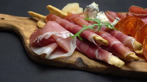 A beautiful serving board of bacon pastrami and sausage. Slow motion Stock Footage 133604785