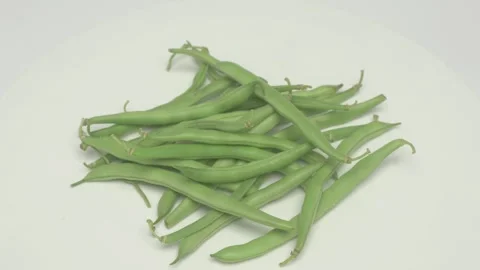 A Beautiful Serving of Fresh Green Beans Arranged Nicely on a Crisp, Elegant Видео 283567023