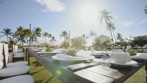Beautiful serving wedding table waiting for guests under sunshines on resort Stock Footage 101116154